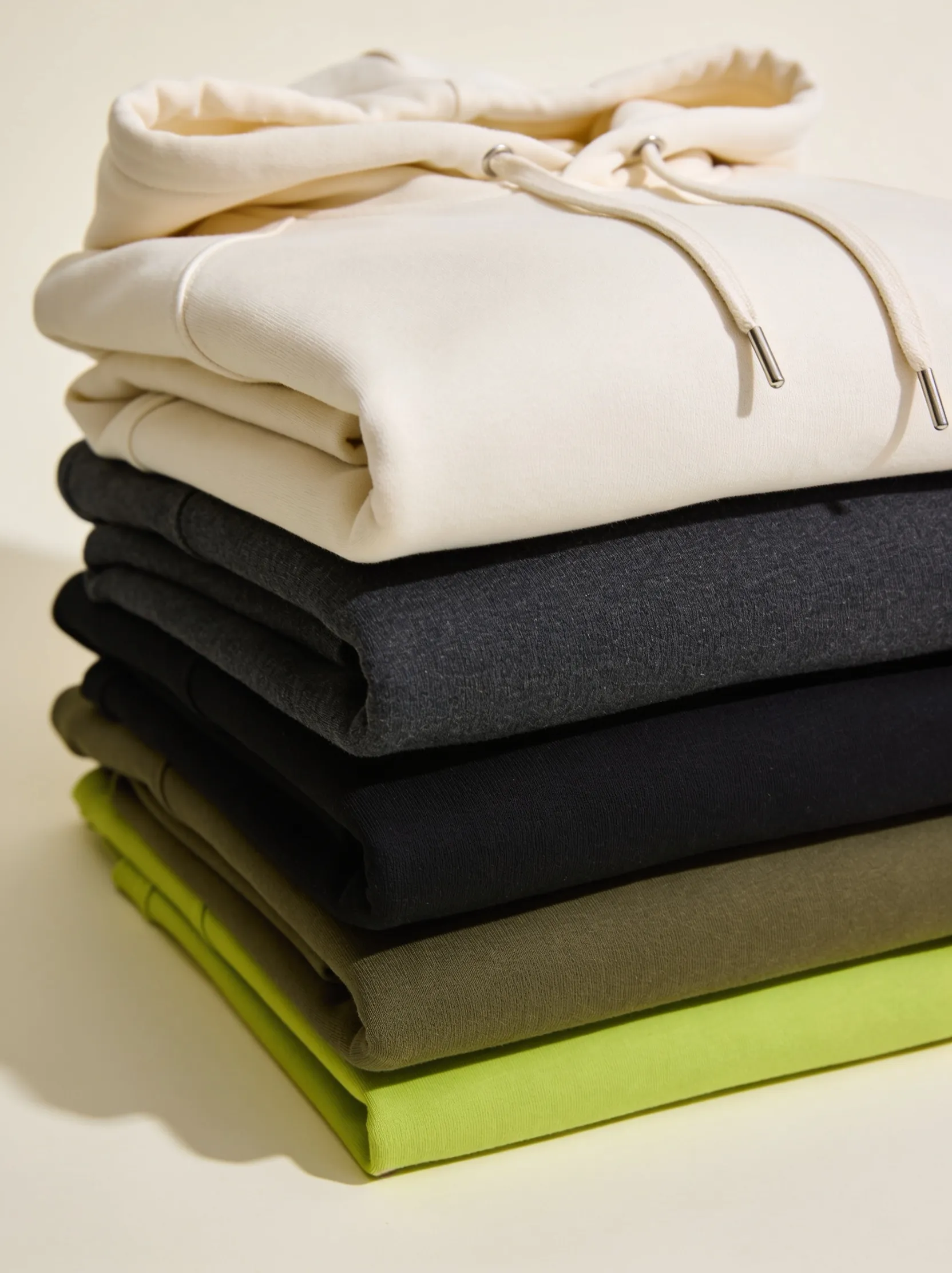 Custom branded apparel — folded hoodies and t-shirts in brand colours